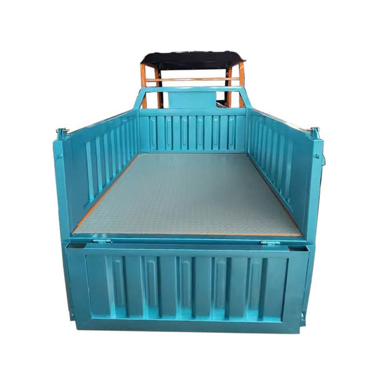 Grey Diamond Plate Cargo Bed Mat installed in the blue bed of a Llama Truck utility vehicle.