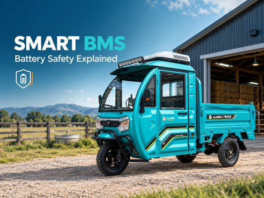 Turquoise LLAMA Truck three-wheeled utility vehicle parked beside a farm barn, illustrating smart battery management system (BMS) technology, lithium battery safety, cell balancing, and thermal protection.