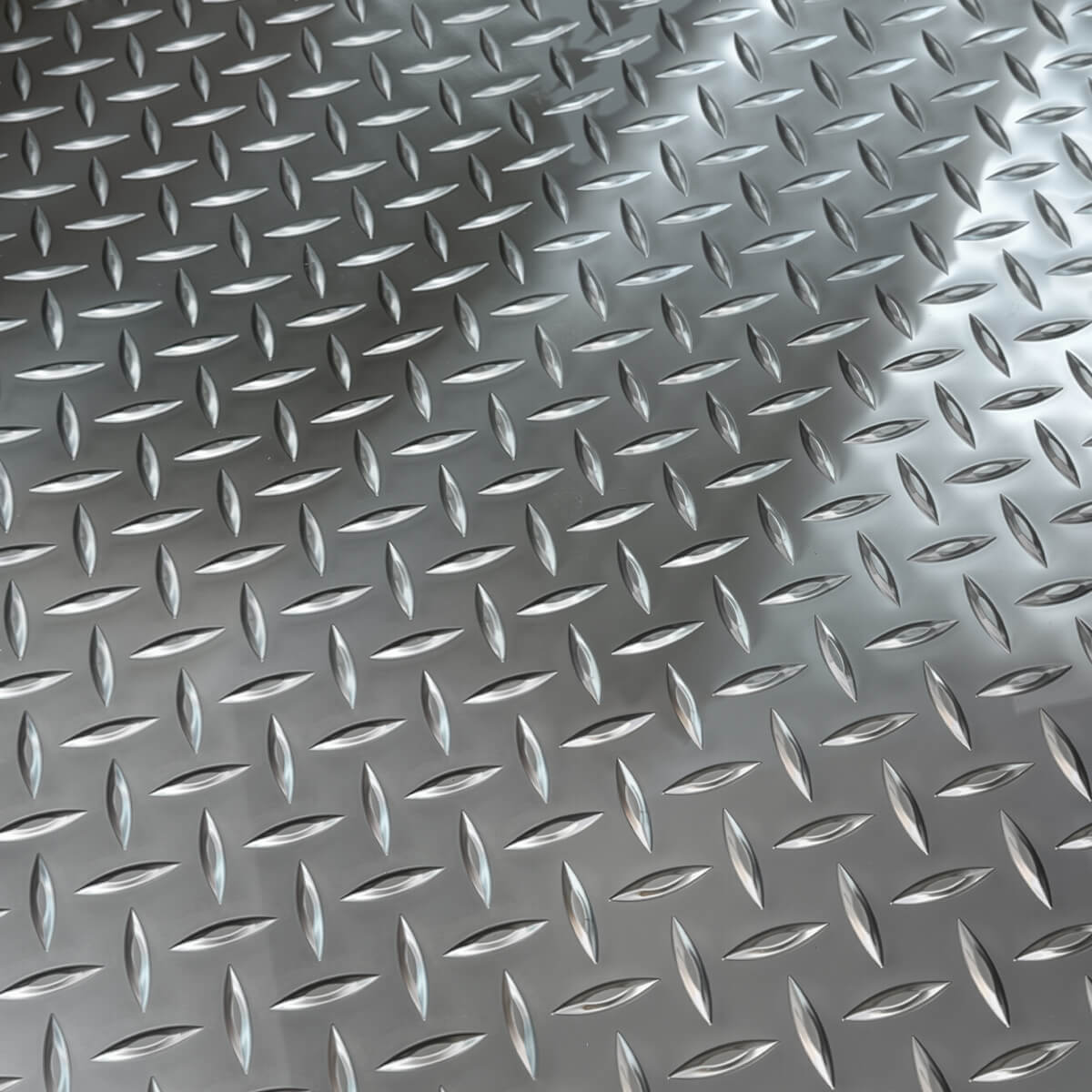 Close-up of silver anti-slip diamond plate texture on Llama Truck fire-retardant cargo bed mat.