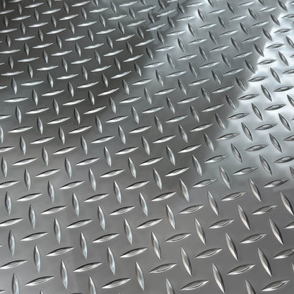 Close-up of silver anti-slip diamond plate texture on Llama Truck fire-retardant cargo bed mat.